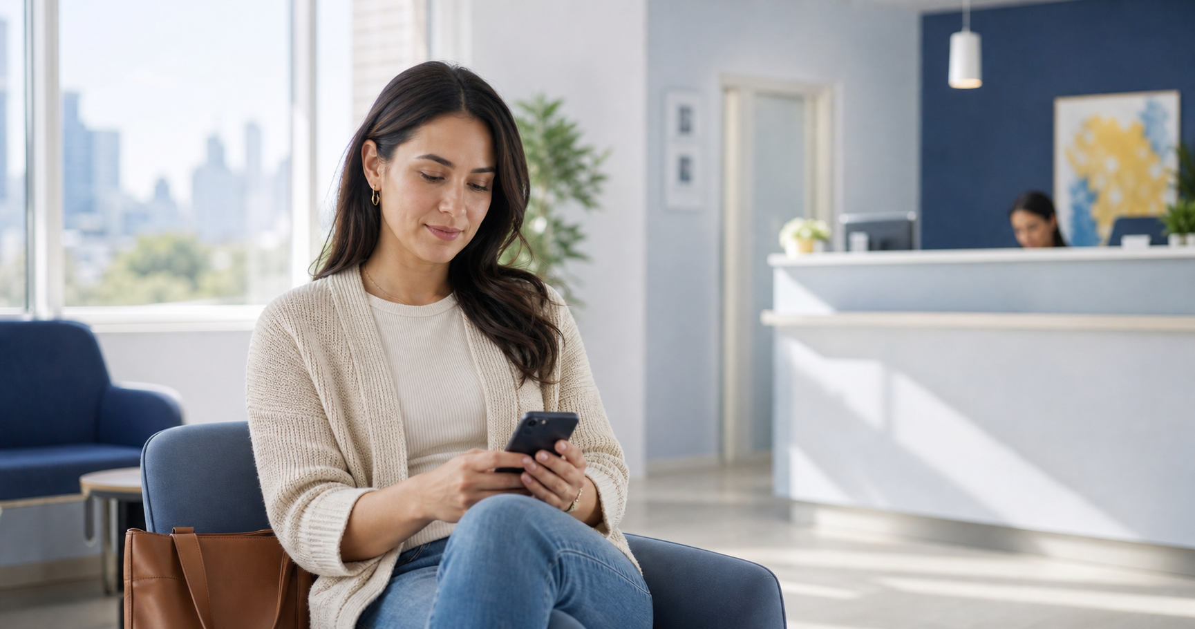 A patient checking appointment details on her phone in a clinic waiting room in New York